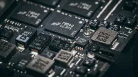 Detailed close-up of electronic microchips on a circuit board, showcasing technology and engineering intricacies.