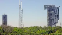 View of rocket launch gantry towers at Kennedy Space Center, Florida under clear sky.