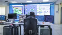 Operator in a modern control room managing technological systems in El Agustino, Lima.