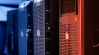 Close-up of tower servers in a data center with blue and red lighting.