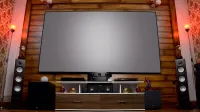 Stylish home theater featuring large screen, audio system, and decor, perfect for entertainment.