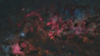A breathtaking view of a nebula with vibrant colors and distant stars in the cosmos.