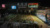 A vibrant outdoor concert at the Asia Culture Center, bustling with a lively crowd at night.