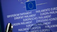 Close-up view of the European Union flag with multilingual text showing European Parliament.
