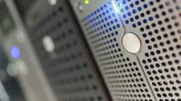 Focused detail of a modern server rack with blue LED indicators in a data center.