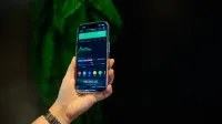 Close-up of a smartphone displaying a stock trading app with market data on-screen.