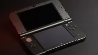 Detailed photo of a Nintendo 3DS console with dual screens and buttons, perfect for gaming enthusiasts.