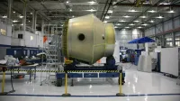 Pesado detalle de la nave espacial colocada en la plataforma rodante en construcción en la fábrica de cohetes futurista