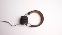 Minimalist image of black over-ear headphones on a white background.