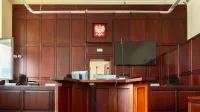 Elegant wooden interior of a courtroom in Wrocław, showcasing judicial decor.