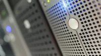 Focused detail of a modern server rack with blue LED indicators in a data center.