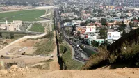 A small fence separates densely-populated Tijuana, Mexico, right, from the United States in the Border Patrol's San Diego Sector.
