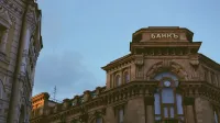 Classic architectural style of a historic bank building under clear blue sky.