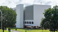 A modern white building surrounded by greenery in Brasília, showcasing sleek architectural design.