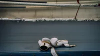 White boxing gloves resting inside an empty boxing ring, symbolizing sports intensity.