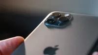 Detailed view of a modern smartphone's triple camera setup in focus.