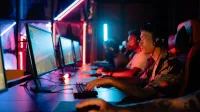 Group of gamers immersed in competitive esports at a cyber arena with neon lighting.