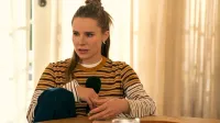 Kristen Bell as Joanne holds a microphone in 'Nobody Wants This' Season 2.