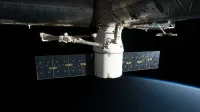 A SpaceX satellite hovering over Earth's horizon in outer space, showcasing advanced space technology.