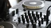 Detailed view of a professional audio mixing console with knobs and controls for sound engineering.