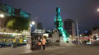 Deliveroo and Just Eat cyclists waiting at the O'Connell Monument for jobs to appear on their app(s).