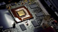 Detailed view of computer processor on motherboard with visible components and circuits.