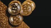 A detailed close-up shot of shiny bitcoin coins resting on a glittery surface, symbolizing wealth in digital currency.