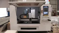 Modern CNC machine in a factory, showcasing advanced industrial automation technology.