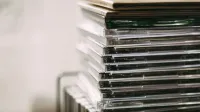 A stack of transparent CD cases neatly aligned, creating a still life composition.
