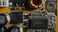Detailed view of microchips and components on a motherboard circuit board.