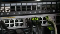 Networking equipment with connected cables, showcasing modern technology infrastructure.