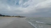 A photo of the Umm Al Quwain beach shores by sunset with the fine sand and clear waters