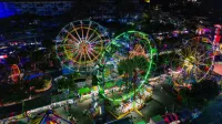 A vibrant aerial view of an amusement park at night in San Salvador, El Salvador.