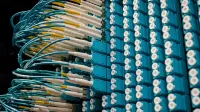 From below of fiber optic equipment with similar colorful rubber cables and round sockets