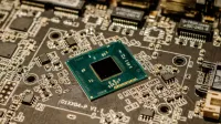 Detailed view of a microchip on a printed circuit board, showcasing electronic components.