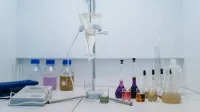 A detailed view of laboratory glassware with colorful chemicals, ideal for scientific research and experiments.