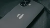 Detailed close-up of a modern smartphone on a textured dark fabric background.