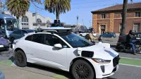 A Waymo Jaguar I-Pace autonomous taxi on the Embarcadero in San Francisco