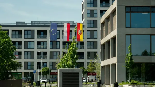 Contemporary architecture in Wrocław, Poland with flags of EU, Poland, and Wrocław.
