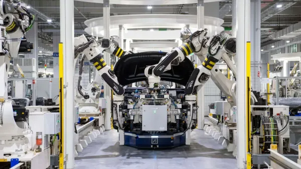 High-tech robots assembling a car in a modern factory setting, showcasing automation.