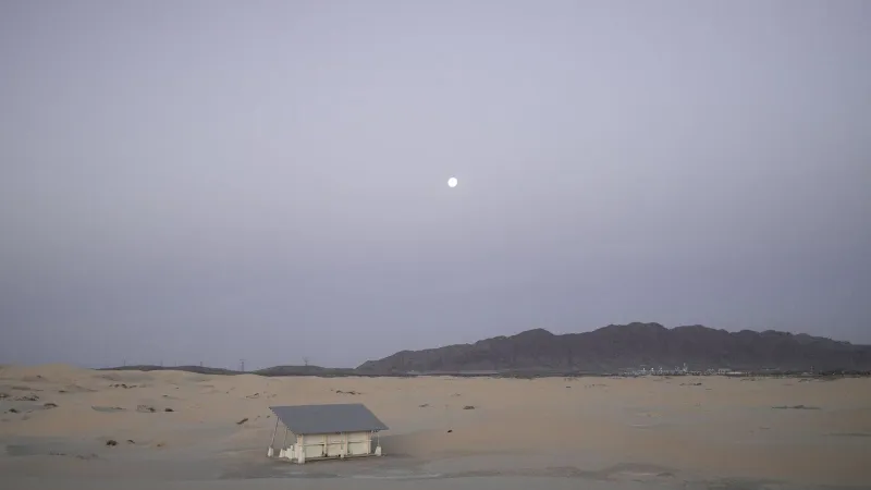 Serene view of an abandoned house in Samalayuca Desert under the early morning moonlight.