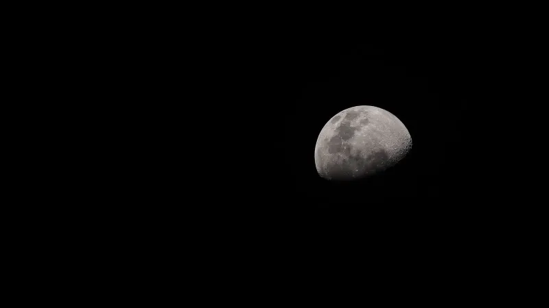 A crescent moon captured in detail against a dark night sky.