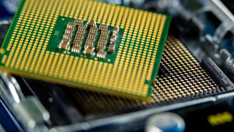 Detailed close-up of a microprocessor on a motherboard showcasing its intricate design.