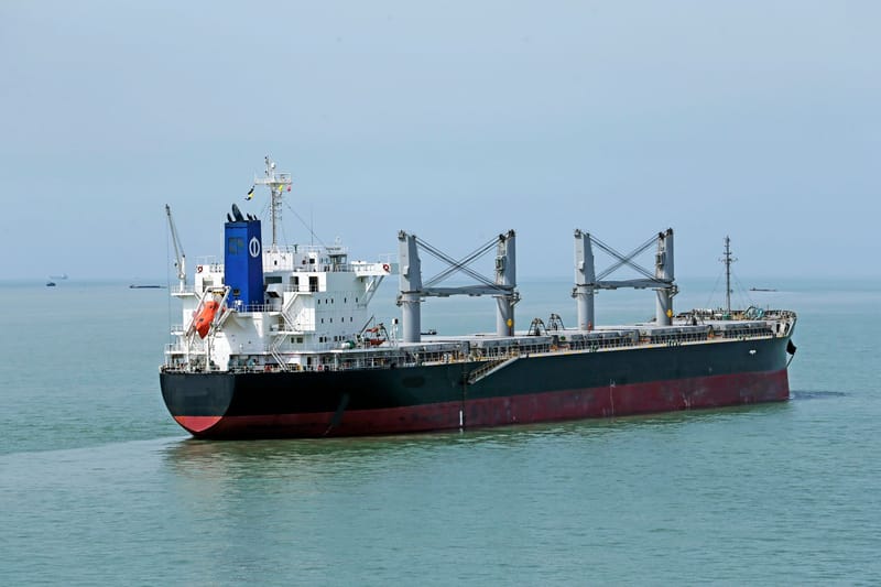 Cargo vessel navigating the calm waters of the open sea.
