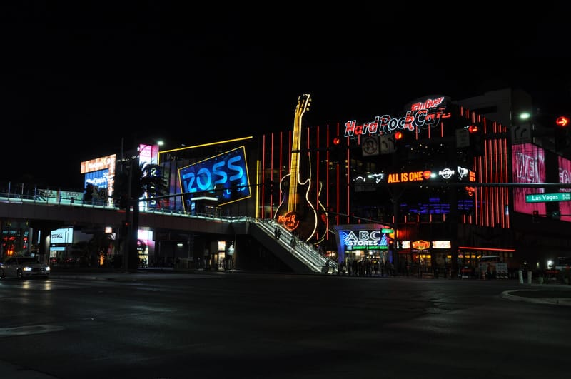 Night view of the vibrant Las Vegas Strip with neon lights and iconic landmarks.