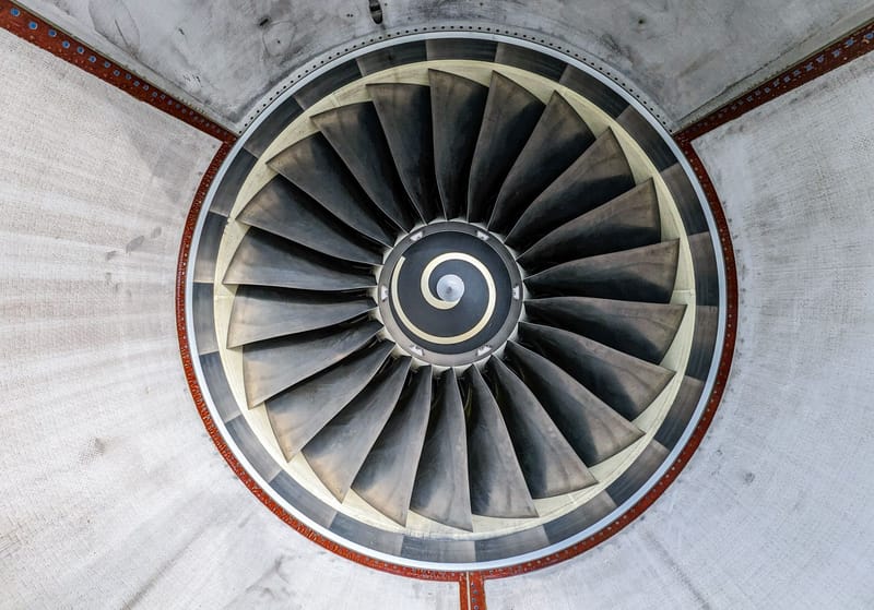 Detailed overhead view of industrial jet engine turbine blades showcasing intricate patterns.
