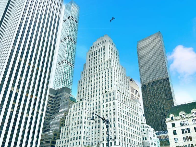 A stunning view of skyscrapers against a bright blue sky in Manhattan's downtown area.