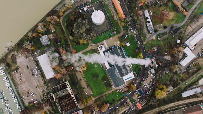 Aerial shot showcasing industrial buildings and smoke in Beograd, Serbia.