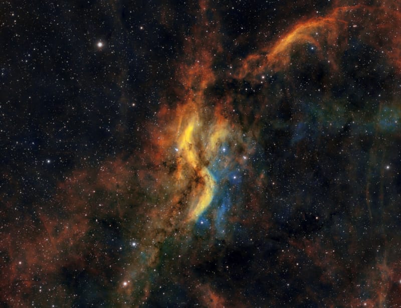 Dynamic scene of colorful gas clouds and stars in a cosmic nebula.