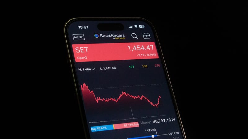 Close-up of a smartphone showing a stock market chart with financial data and analytics.